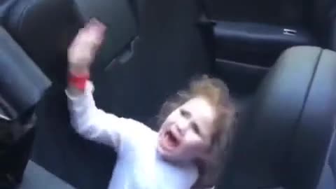 Little girl is not familiar with the function of this car.