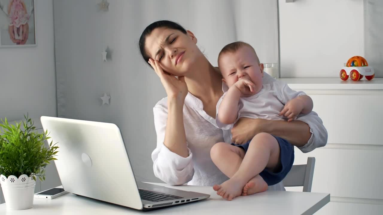 Mom tries to work from home taking care of a baby