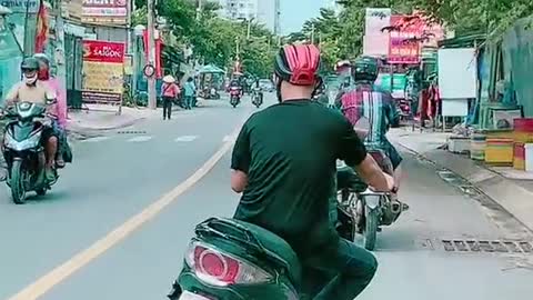 The young man driving a strange motorbike looks like it's broken in two