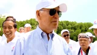 Biden meets Russian guy carrying a guns.