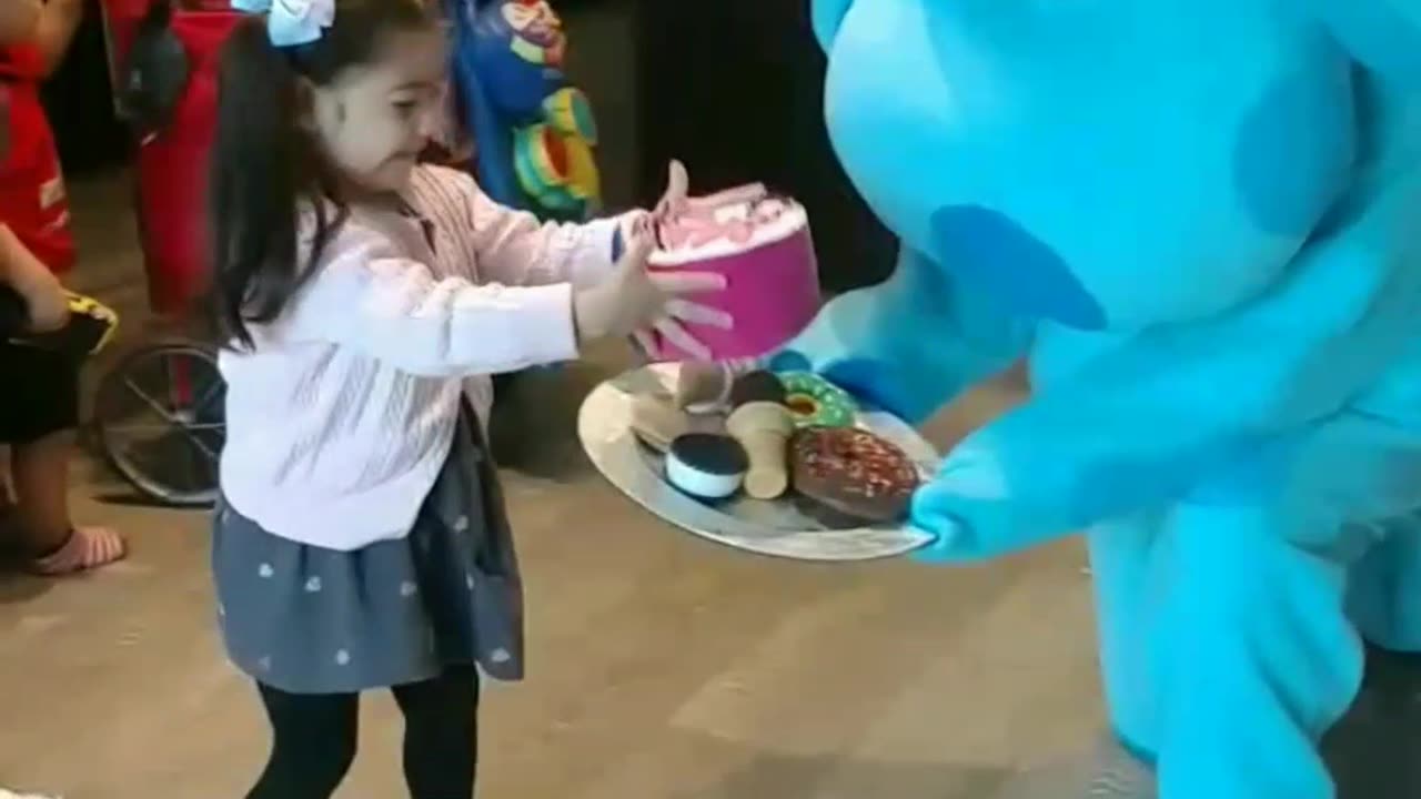 See this Blue dog play the birthday party treats at the birthday celebration