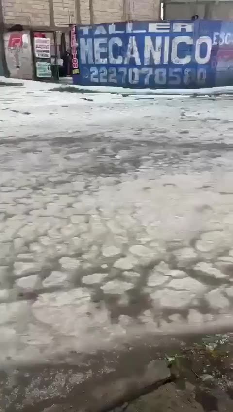 The hailstorm flow at street in the Amalucan area in Puebla, Mexico...