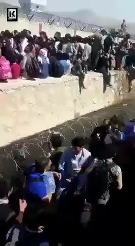 People at Kabul Airport standing in sewage water to get in
