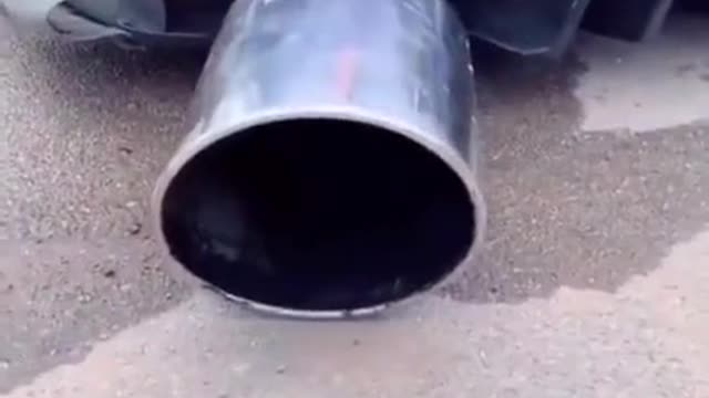 The exaggerated exhaust pipe of a car is modified and repaired.