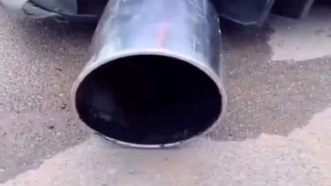 The exaggerated exhaust pipe of a car is modified and repaired.