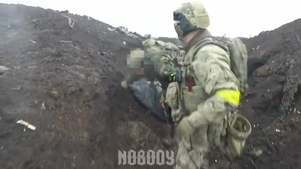 Ukrainian soldiers moving into a trench during the defense of the road to Bakmut