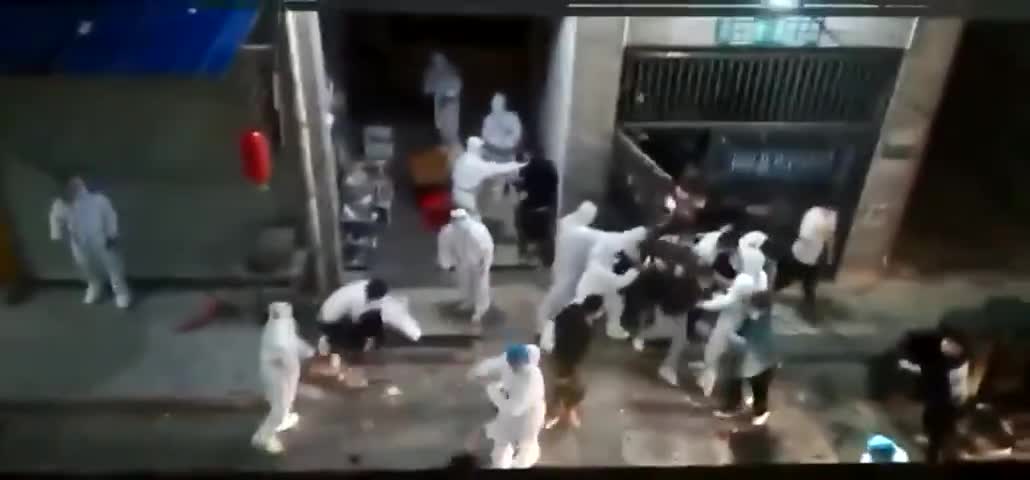 Crowd escapes from housing complex lockdown in Shanghai.