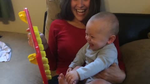 Baby laughs hysterically at 'Guess Who?' game