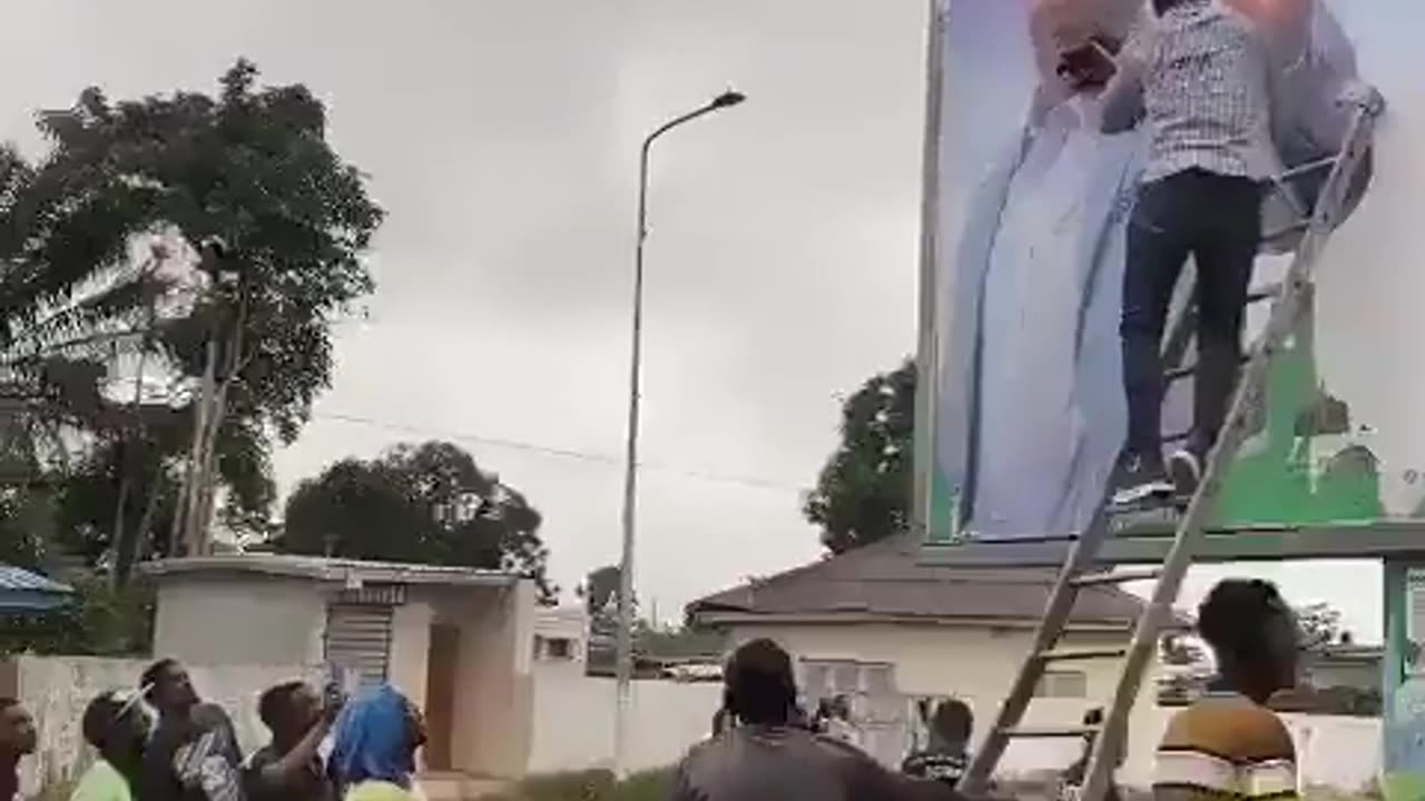 Billboard of the Gabon President being smeared by the people after the military coup