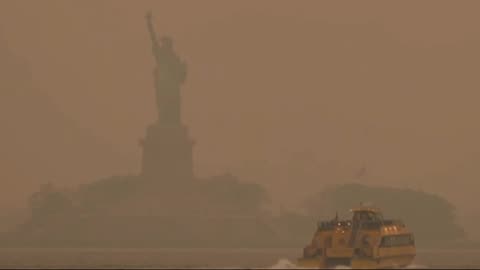 Statue of Liberty seen through smoky wildfire haze in NYC