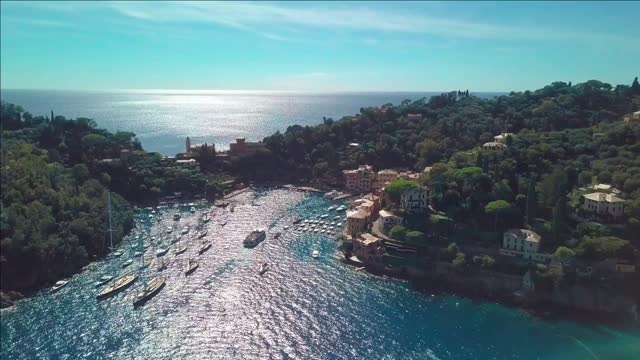 portofino italy vessels move through strait near coastal town at summer sunny day aerial view