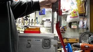 A third hand for a Lee scissor press.