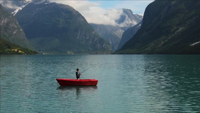 woman fishing on fishing rod spinning in norway