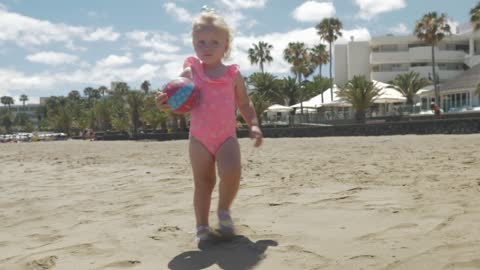 Toddler holding a small ball