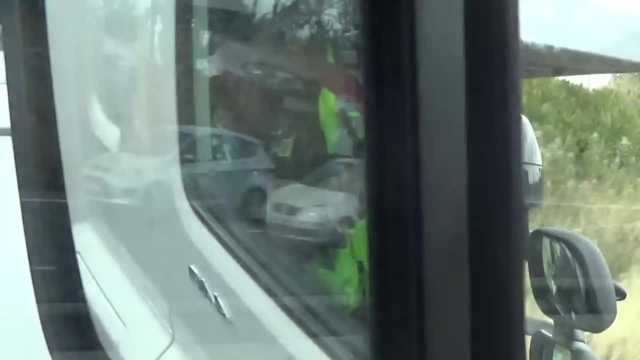 Truck driver uses two cell phones simultaneously while driving