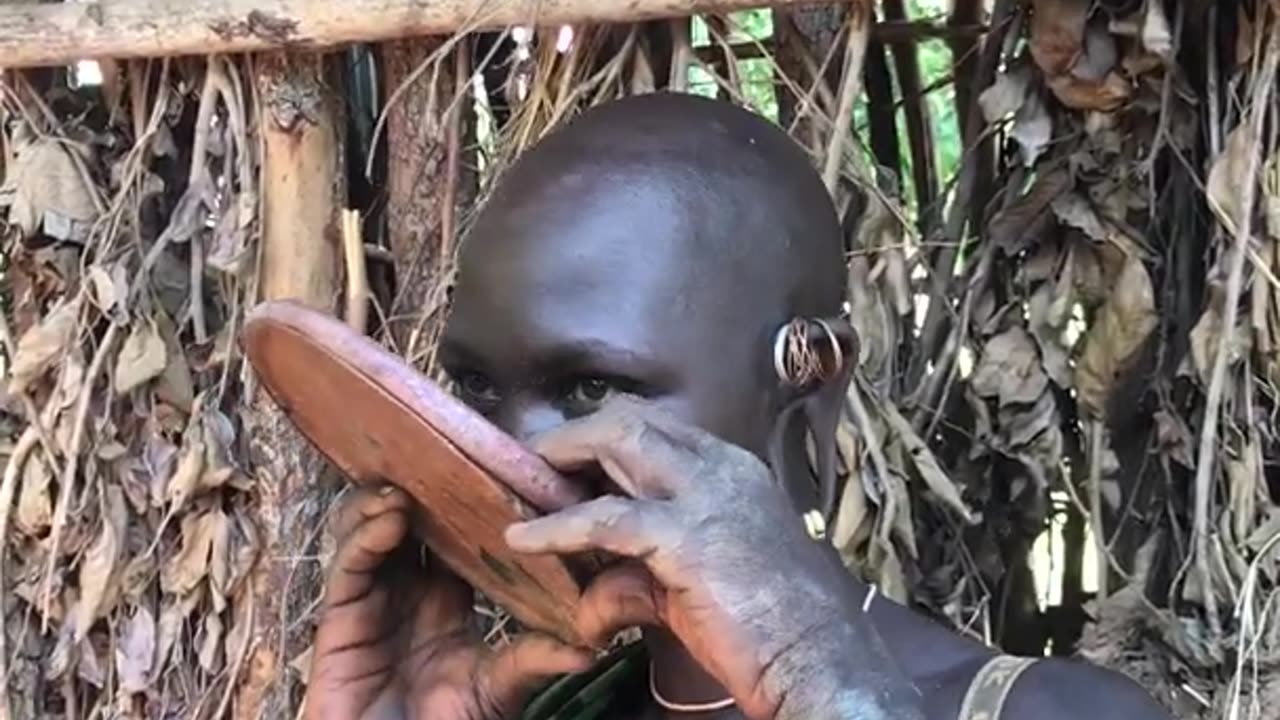 The lady from suri tribe inserting lip plate