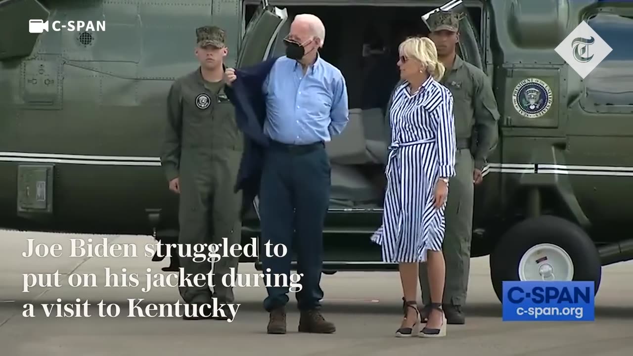 Joe Biden struggles to get his jacket on before dropping his sunglasses