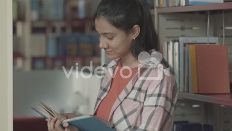 Pretty Girl Reading A Book In The Library