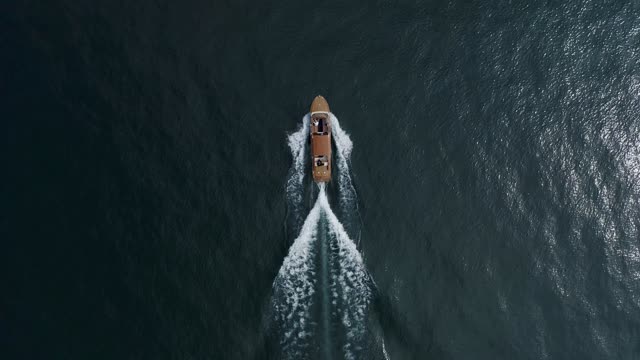 Drone Footage of a Motorboat Leaving a Water Trail