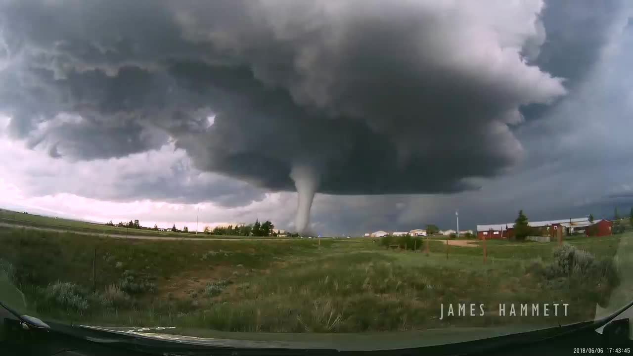 Storm chasing dashcam: Tornado crossing the highway! Laramie, Wyoming