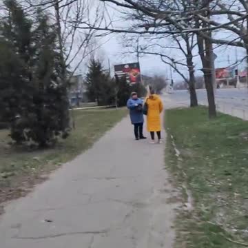 In Kherson, locals watch Russian soldiers in the city on their way to work