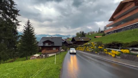 Grindelwald walking on the rain enjoying umbrella walking in the beautiful village switzerland