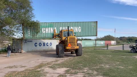 Texas forced to build makeshift walls using shipping containers with barbwire attached