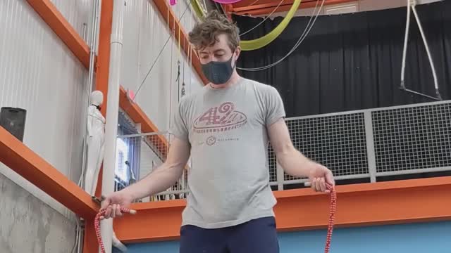 Guy Skips Jump Rope While Balancing Himself on Balance Board