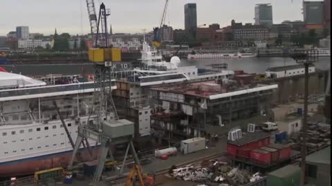 Drone footage of the manufacturing process of a large ship.