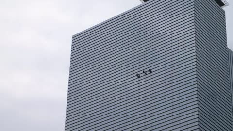 Window Cleaners Cleaning Skyscraper
