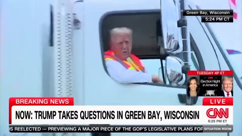 Trump speaks to the press from a garbage truck