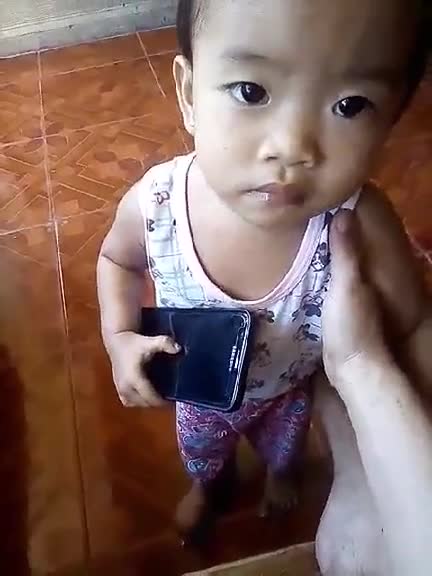 Little Filipina Girl is Startled while using phone