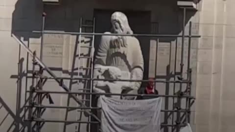 Spiderman' scales the BBC statue symbolising pedophilia..