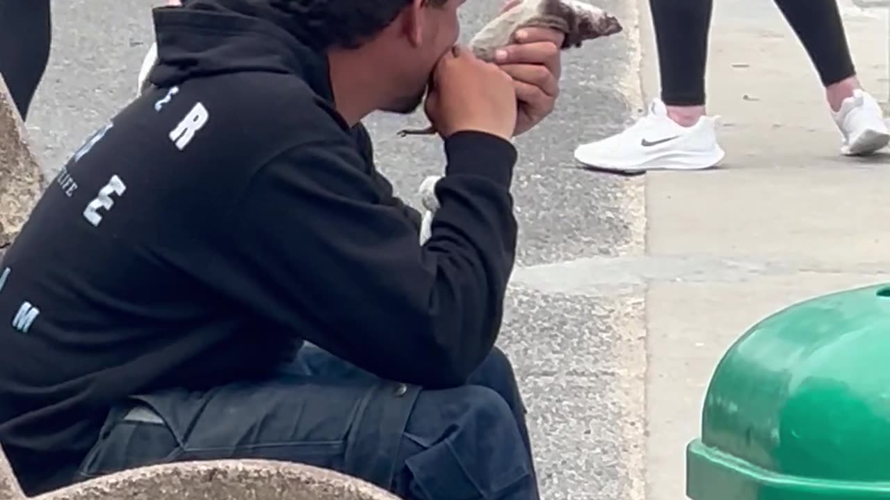 Homeless Man Eats A Rat