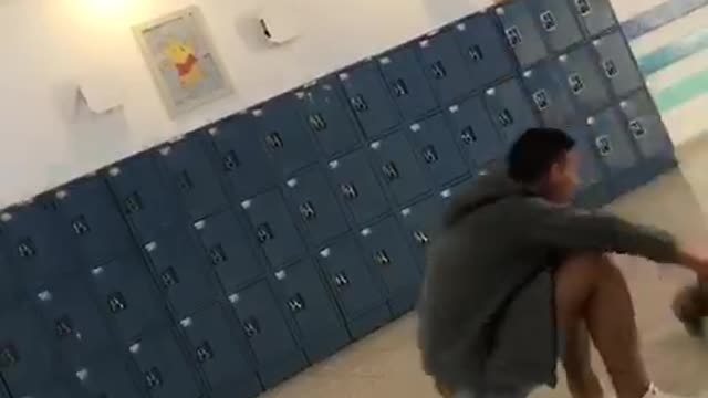 Guy ducks leap frog in front of school lockers friend faceplants