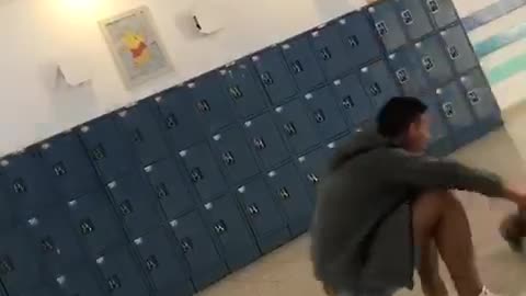 Guy ducks leap frog in front of school lockers friend faceplants