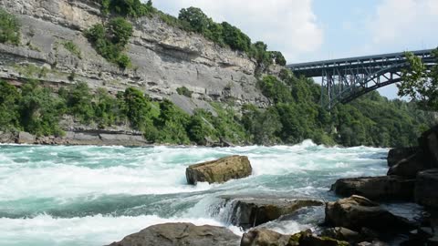 River with strong current - a bridge from above