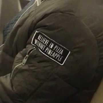 Man green jacket black patch