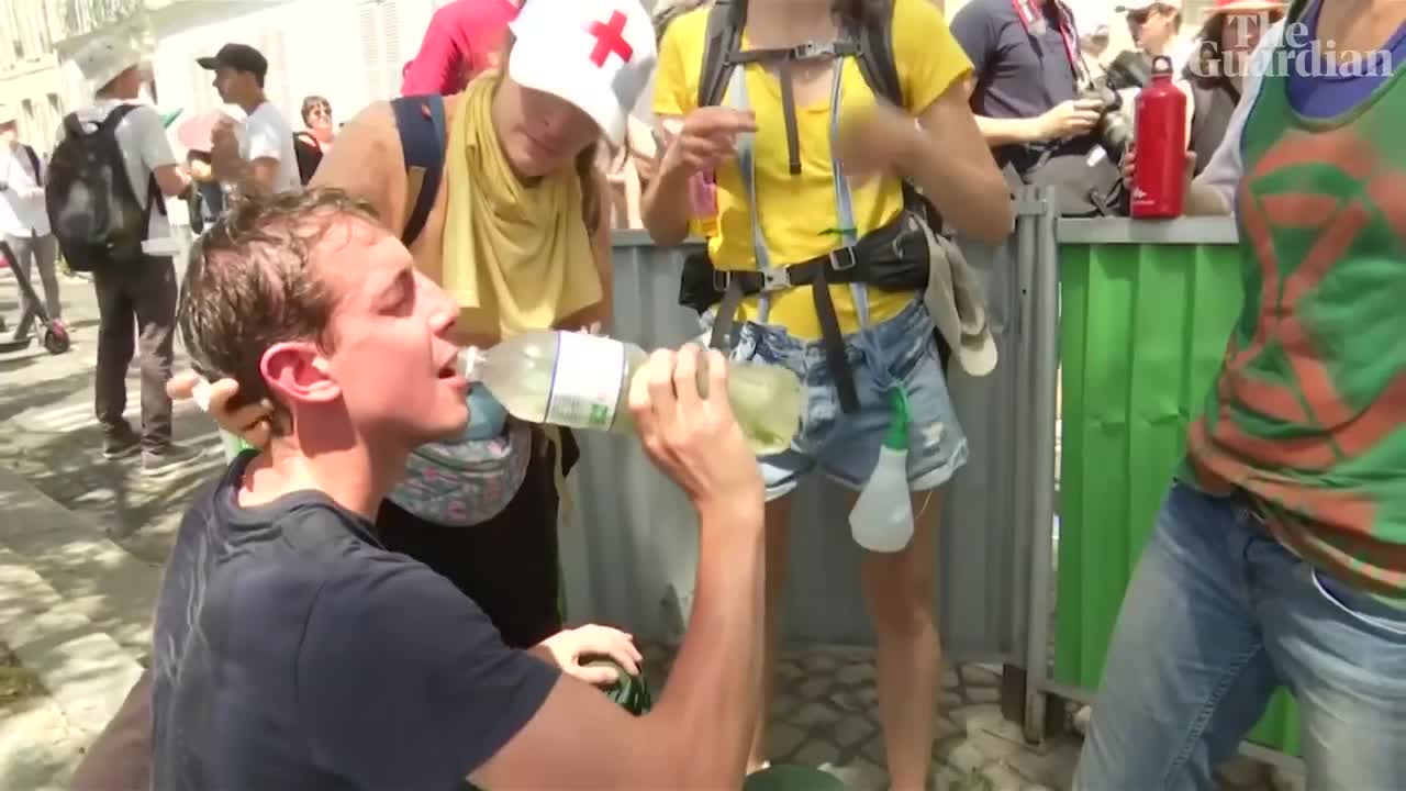 Police use pepper spray on seated climate protesters in Paris