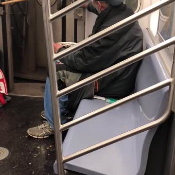 Old guy with backwards hat smoking on subway