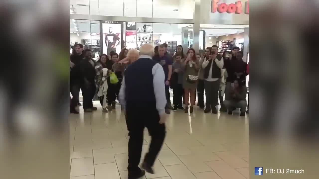 Elderly couple adorably dance together while on vacation