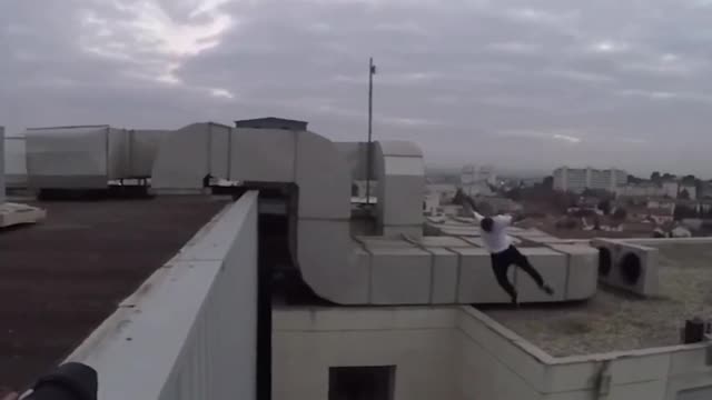 Guy white shirt black pants jumps from buildings