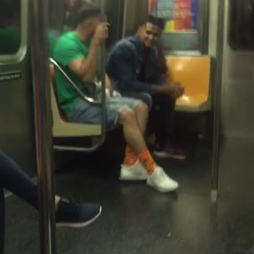 Man in a green shirt and white shoes dances
