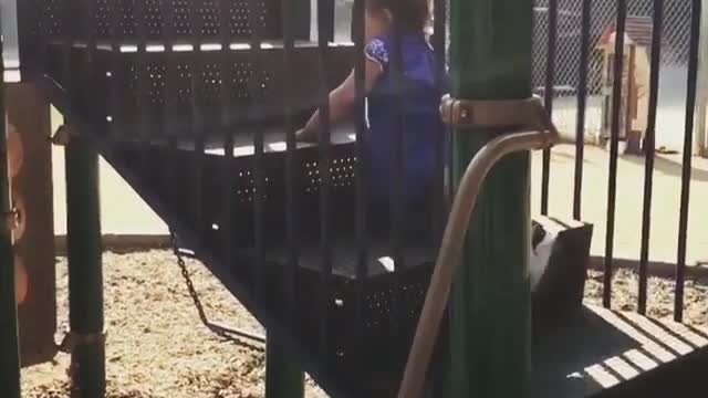 Baby girl in purple faceplants on slide