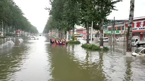 Rescuers use construction loaders in flood-hit China