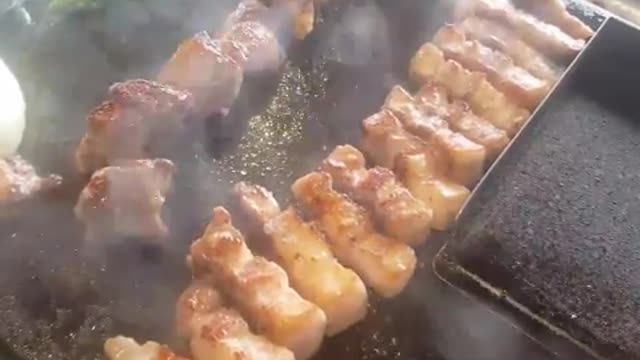 The sound of grilling pork belly