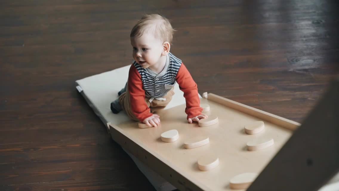 A Baby Boy Trying to Crawl Up