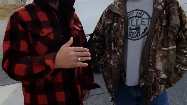 Dr. Paul Elias Alexander speaks with trucker Craig at the convoy in Hagerstown, MA