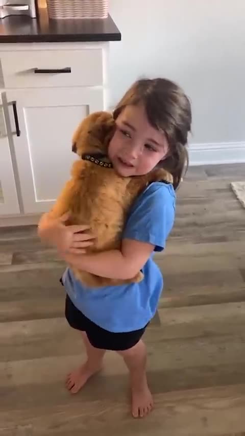 Little girl sobs as she holds her new puppy