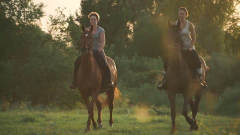 Two girls ride horses